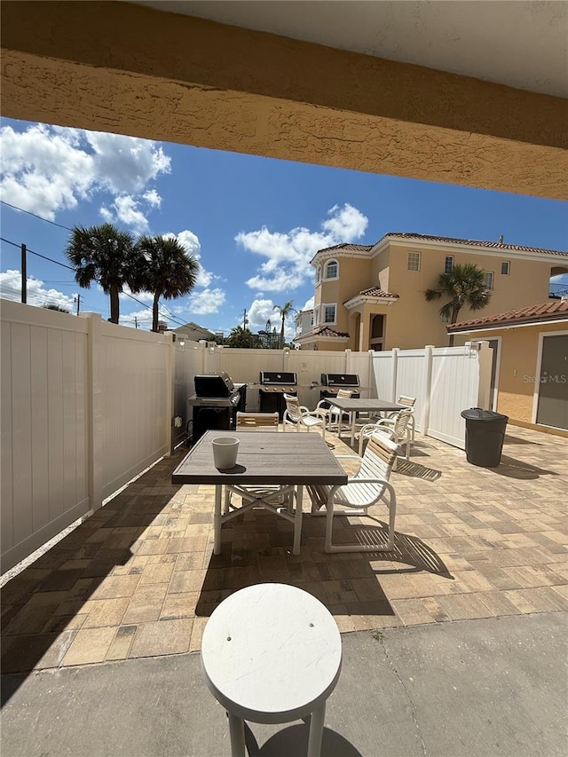 13440 Gulf Blvd Unit 501, Madeira Beach, FL 33708 - view of patio with outdoor dining space and a grill