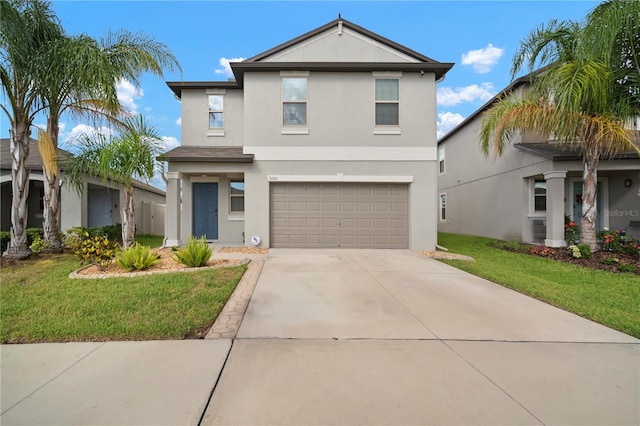 9640 Lemon Drop Loop, Ruskin, FL 33573 - traditional-style house with stucco siding, a garage, driveway, and a front lawn