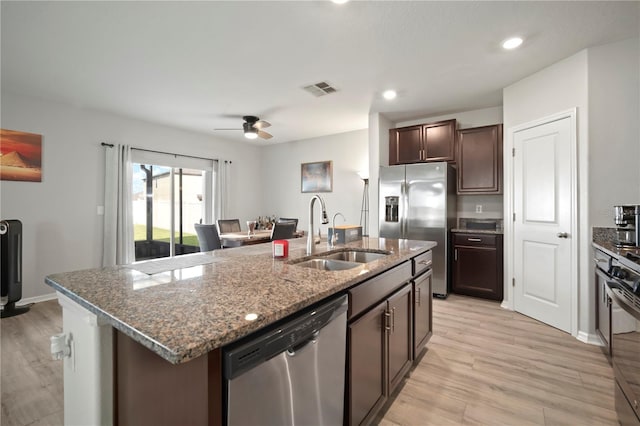 9640 Lemon Drop Loop, Ruskin, FL 33573 - kitchen with stainless steel appliances, a sink, light wood-style flooring, stone countertops, and recessed lighting