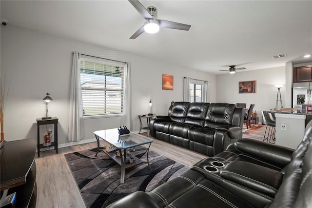 9640 Lemon Drop Loop, Ruskin, FL 33573 - living room featuring ceiling fan, light wood-style flooring, and baseboards