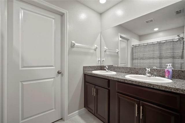 9640 Lemon Drop Loop, Ruskin, FL 33573 - bathroom featuring double vanity and baseboards