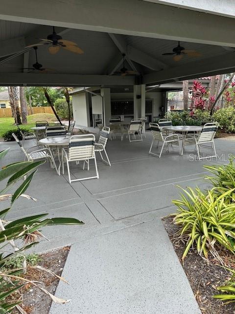 view of patio / terrace with outdoor dining space, ceiling fan, and fence