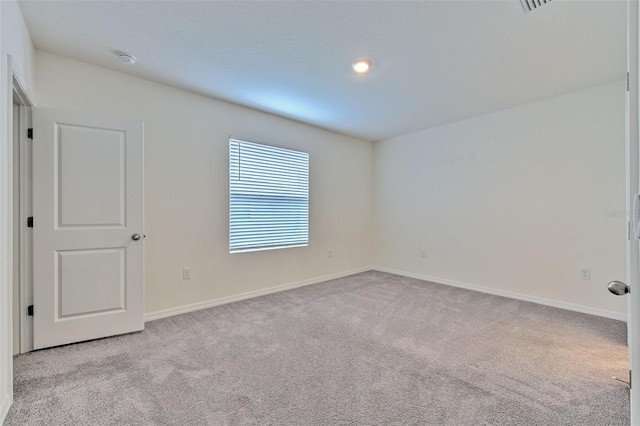 2882 Peony Prairie Ln, Wesley Chapel, FL 33543 - empty room featuring light colored carpet and a smoke detector