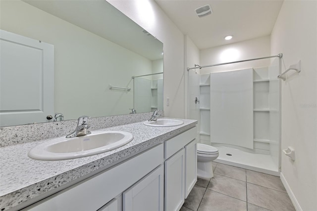 2882 Peony Prairie Ln, Wesley Chapel, FL 33543 - bathroom featuring a shower, tile patterned floors, and double vanity