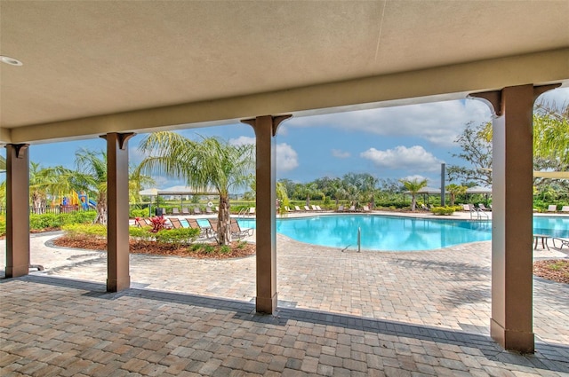 2882 Peony Prairie Ln, Wesley Chapel, FL 33543 - community pool featuring a patio