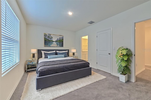 2882 Peony Prairie Ln, Wesley Chapel, FL 33543 - carpeted bedroom featuring baseboards and ensuite bathroom