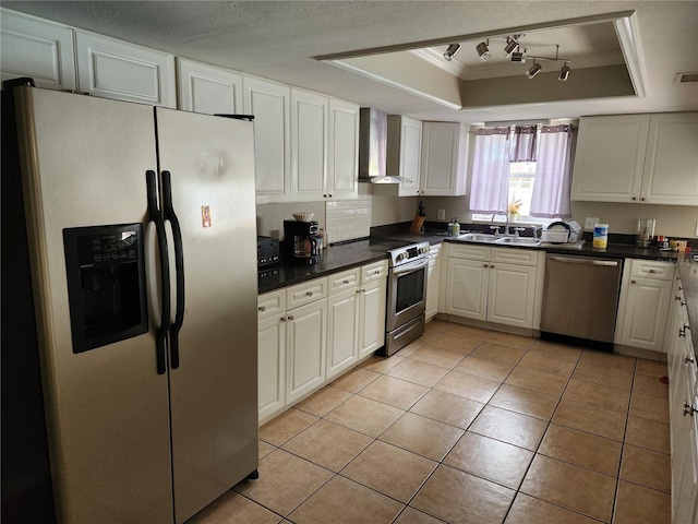 6906 Shady Pl, Tampa, FL 33634 - kitchen with stainless steel appliances, wall chimney exhaust hood, a tray ceiling, a sink, and dark countertops