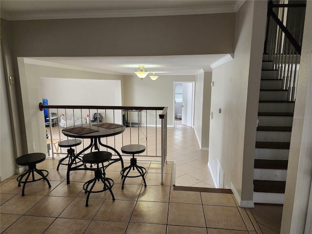 6906 Shady Pl, Tampa, FL 33634 - tiled dining space with stairway, crown molding, and baseboards