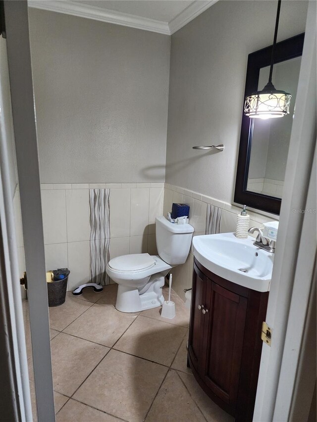 6906 Shady Pl, Tampa, FL 33634 - half bath with crown molding, tile walls, toilet, vanity, and tile patterned floors