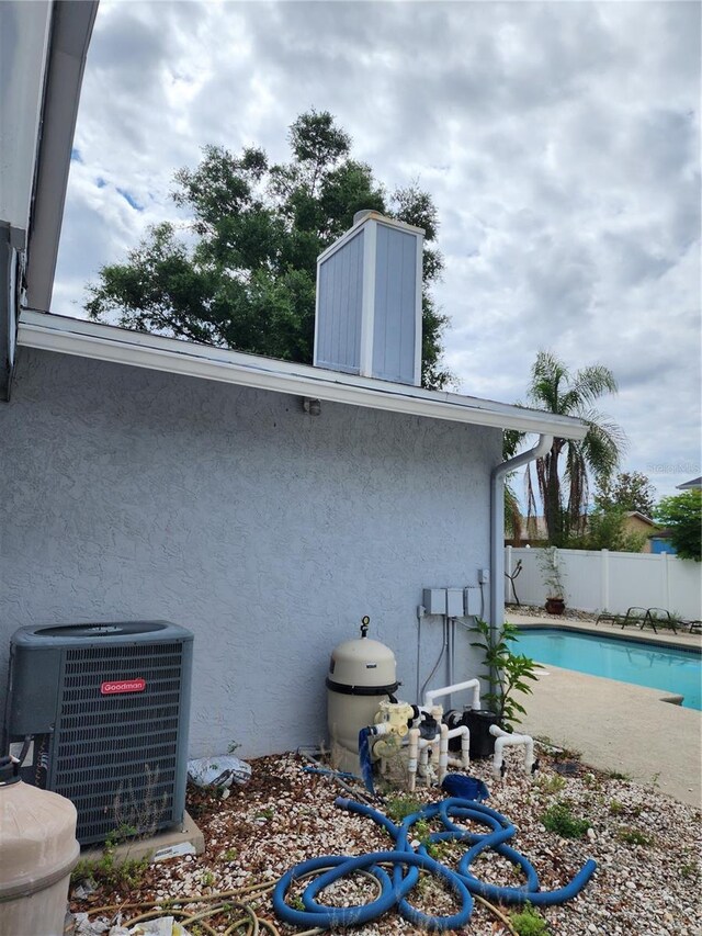 6906 Shady Pl, Tampa, FL 33634 - view of property exterior featuring cooling unit, fence, a chimney, and stucco siding