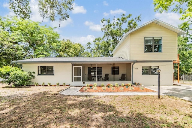 1225 15th St, Palm Harbor, FL 34683 - back of property with a sunroom, a ceiling fan, and fence