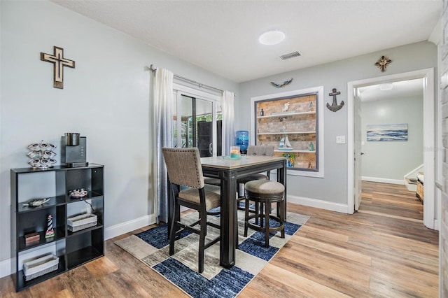 1225 15th St, Palm Harbor, FL 34683 - dining area with wood finished floors and baseboards