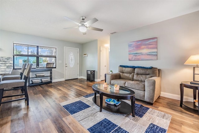 1225 15th St, Palm Harbor, FL 34683 - living room with ceiling fan, wood finished floors, and baseboards