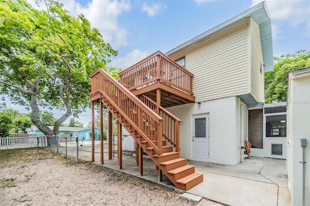 1225 15th St, Palm Harbor, FL 34683 - rear view of property with stairs, fence, a wooden deck, a patio, and stucco siding