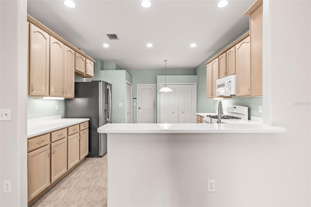 kitchen with white appliances, a peninsula, light brown cabinetry, and recessed lighting
