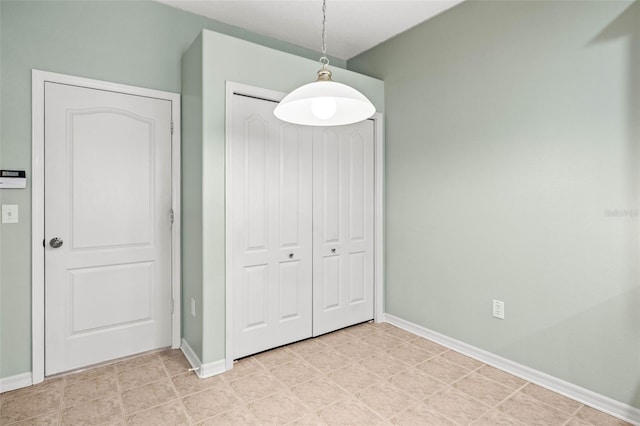 unfurnished dining area with baseboards