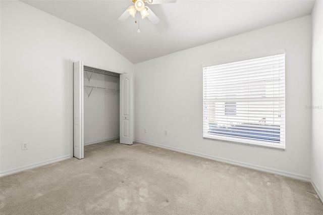 unfurnished bedroom with carpet flooring, baseboards, and vaulted ceiling
