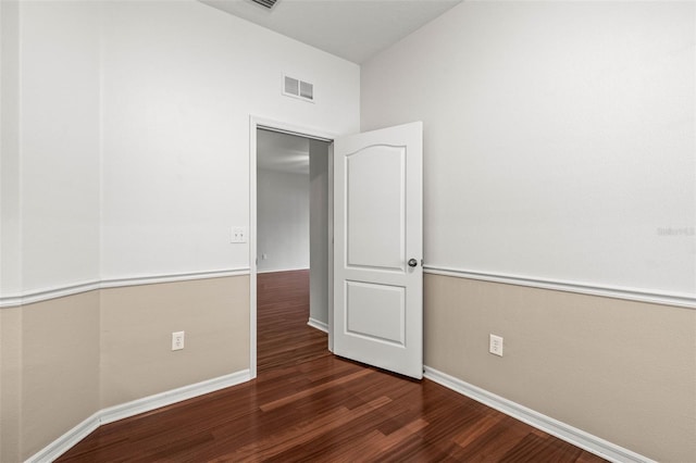 unfurnished bedroom featuring wood finished floors and baseboards