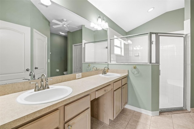 full bathroom with a stall shower, vaulted ceiling, double vanity, ceiling fan, and tile patterned flooring