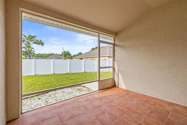 unfurnished sunroom with lofted ceiling