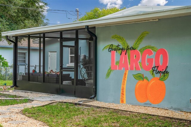 616 11th St NW, Largo, FL 33770 - view of property exterior featuring a sunroom and stucco siding