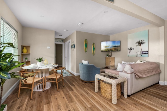 616 11th St NW, Largo, FL 33770 - living room with light wood-style flooring and baseboards