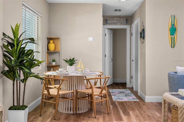 616 11th St NW, Largo, FL 33770 - dining space featuring wood finished floors and baseboards