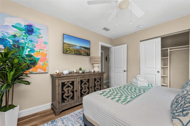 616 11th St NW, Largo, FL 33770 - bedroom featuring baseboards, wood finished floors, a closet, and ceiling fan