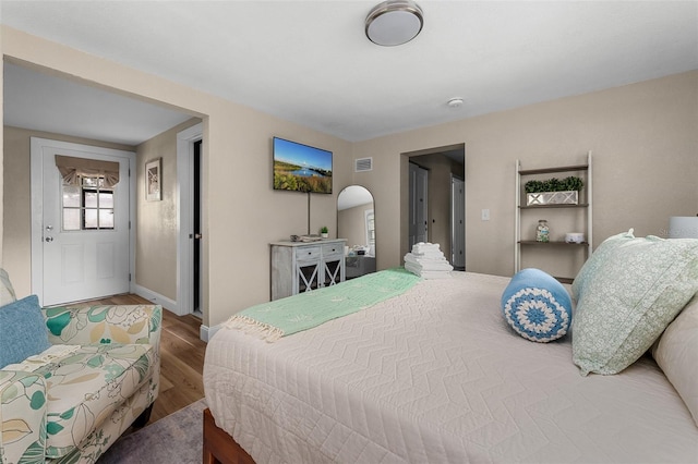 616 11th St NW, Largo, FL 33770 - bedroom with wood finished floors, baseboards, and arched walkways