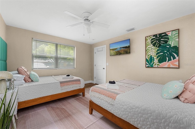 616 11th St NW, Largo, FL 33770 - bedroom featuring wood finished floors, a ceiling fan, and baseboards
