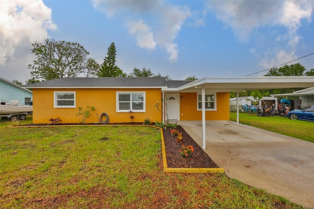 ranch-style house with stucco siding, driveway, a front yard, and an attached carport