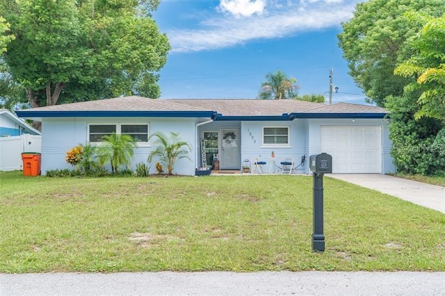 ranch-style home with concrete driveway, a garage, and stucco siding