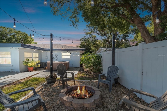 view of yard featuring an outdoor fire pit, a patio, and fence