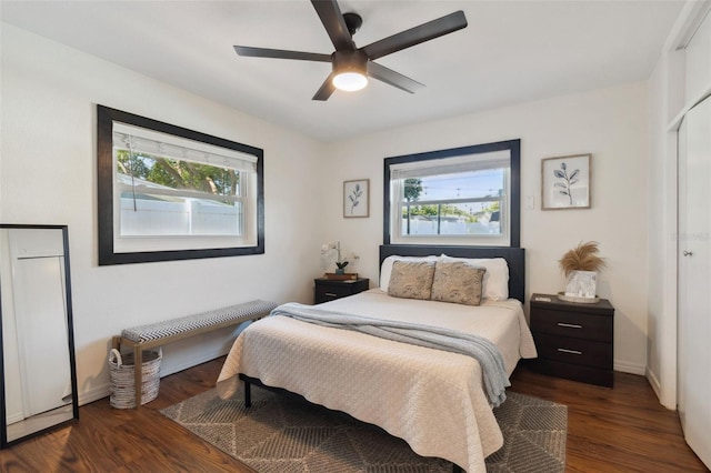 bedroom featuring wood finished floors, a closet, baseboards, and a ceiling fan