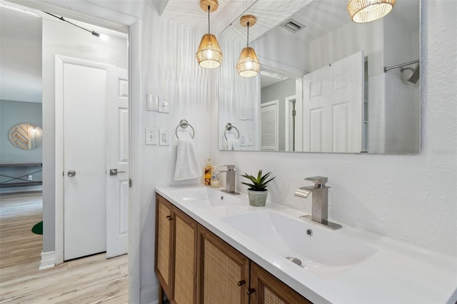 full bathroom with wood finished floors and double vanity