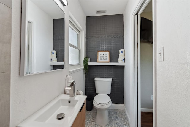 half bathroom featuring toilet and vanity