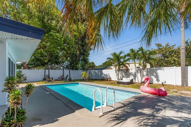 view of pool with a fenced backyard and a patio area