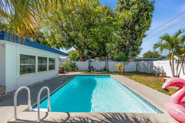 view of swimming pool with a fenced backyard