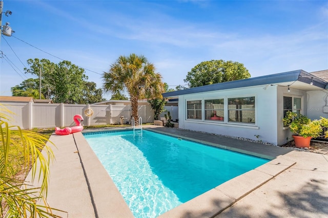view of pool with a fenced backyard and a patio