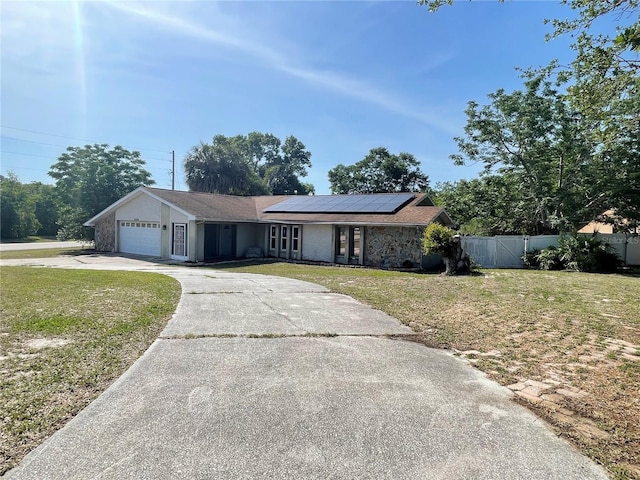 8209 Chaucer Dr, Weeki Wachee, FL 34607 - view of front of home with driveway, solar panels, and a garage