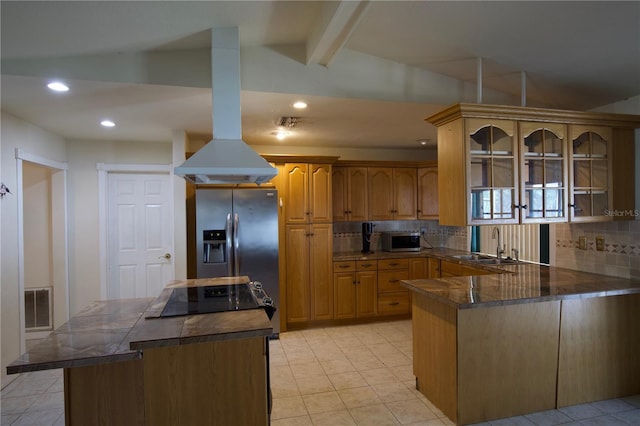8209 Chaucer Dr, Weeki Wachee, FL 34607 - kitchen featuring appliances with stainless steel finishes, island range hood, tasteful backsplash, a peninsula, and dark countertops