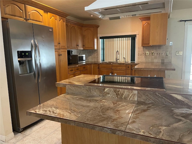 8209 Chaucer Dr, Weeki Wachee, FL 34607 - kitchen featuring appliances with stainless steel finishes, ventilation hood, tasteful backsplash, brown cabinets, and light tile patterned floors