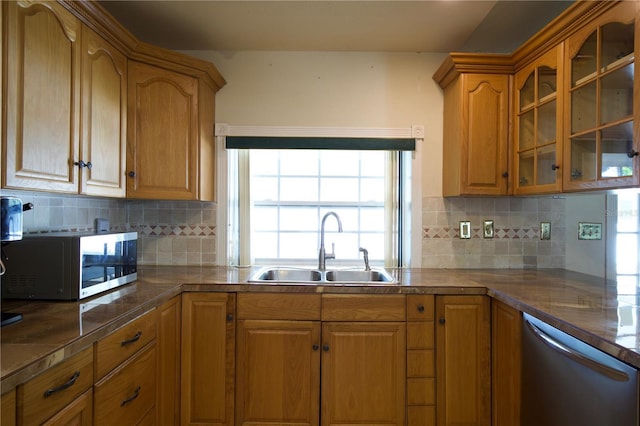 8209 Chaucer Dr, Weeki Wachee, FL 34607 - kitchen featuring appliances with stainless steel finishes, glass insert cabinets, brown cabinets, and backsplash