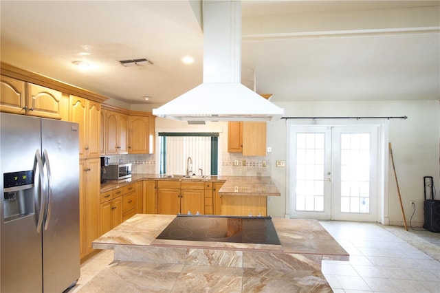 8209 Chaucer Dr, Weeki Wachee, FL 34607 - kitchen with appliances with stainless steel finishes, island exhaust hood, healthy amount of natural light, and backsplash