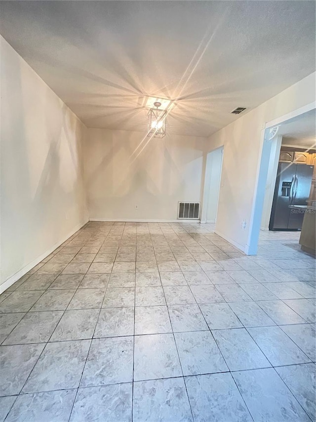 8209 Chaucer Dr, Weeki Wachee, FL 34607 - empty room with baseboards and light tile patterned floors