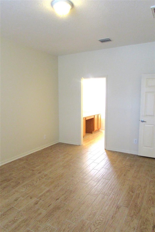 unfurnished room featuring light wood-style floors and baseboards