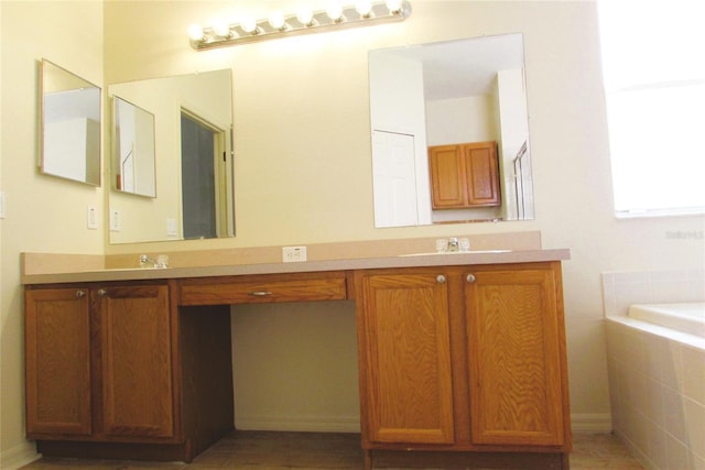 full bathroom featuring double vanity and tiled tub