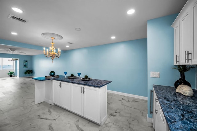 kitchen with light marble finish flooring, baseboards, a chandelier, recessed lighting, and white cabinets