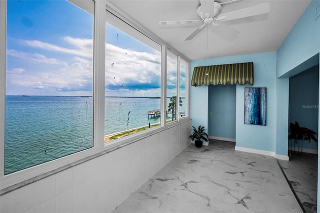 unfurnished sunroom with a water view