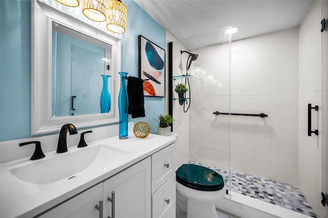 full bath featuring a stall shower, vanity, and toilet